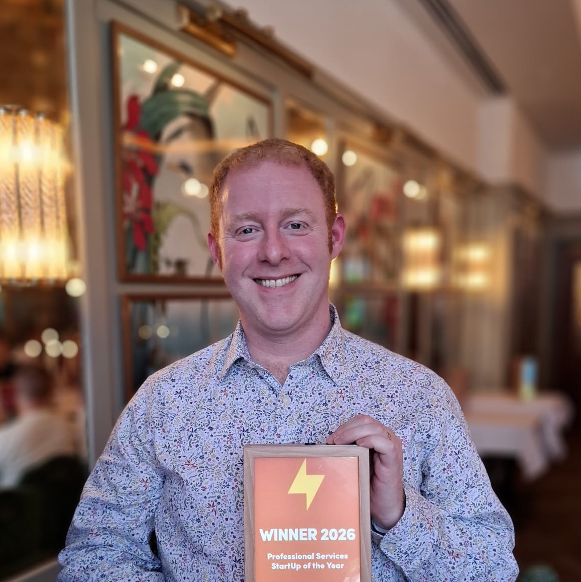 Tony McBride, CV, interview and career transition coach, holding his Winner 2026 Professional Services StartUp of the Year award